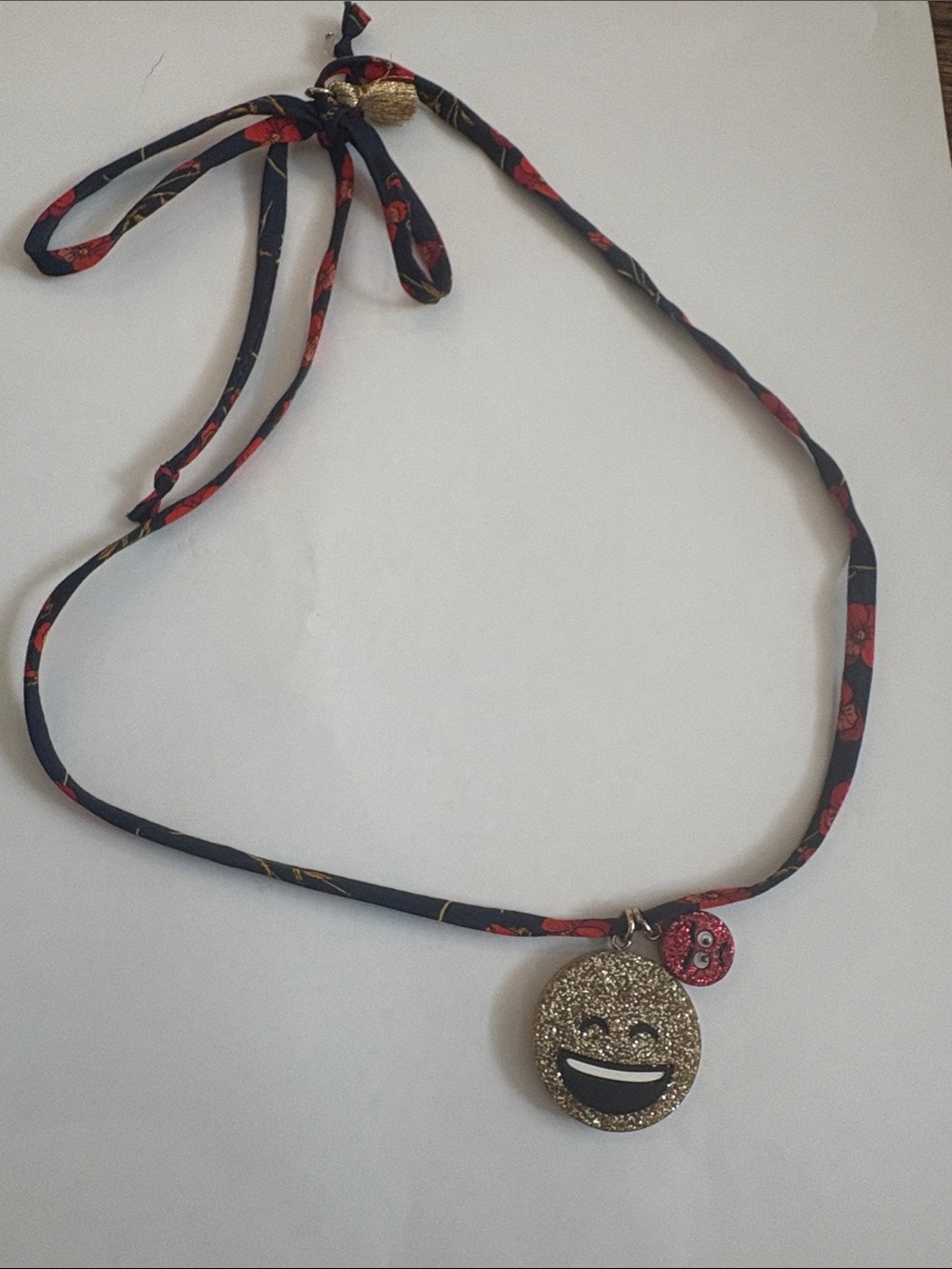Crewcuts emoji necklace on Liberty of London fabric